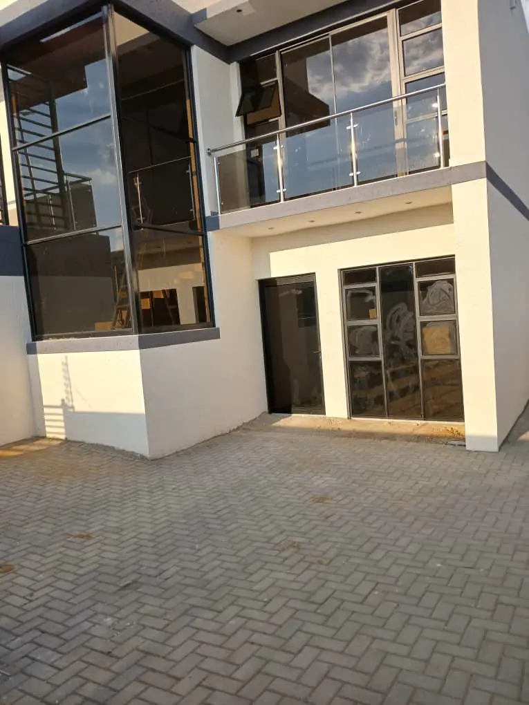 Outside: Paved courtyard in front of the house