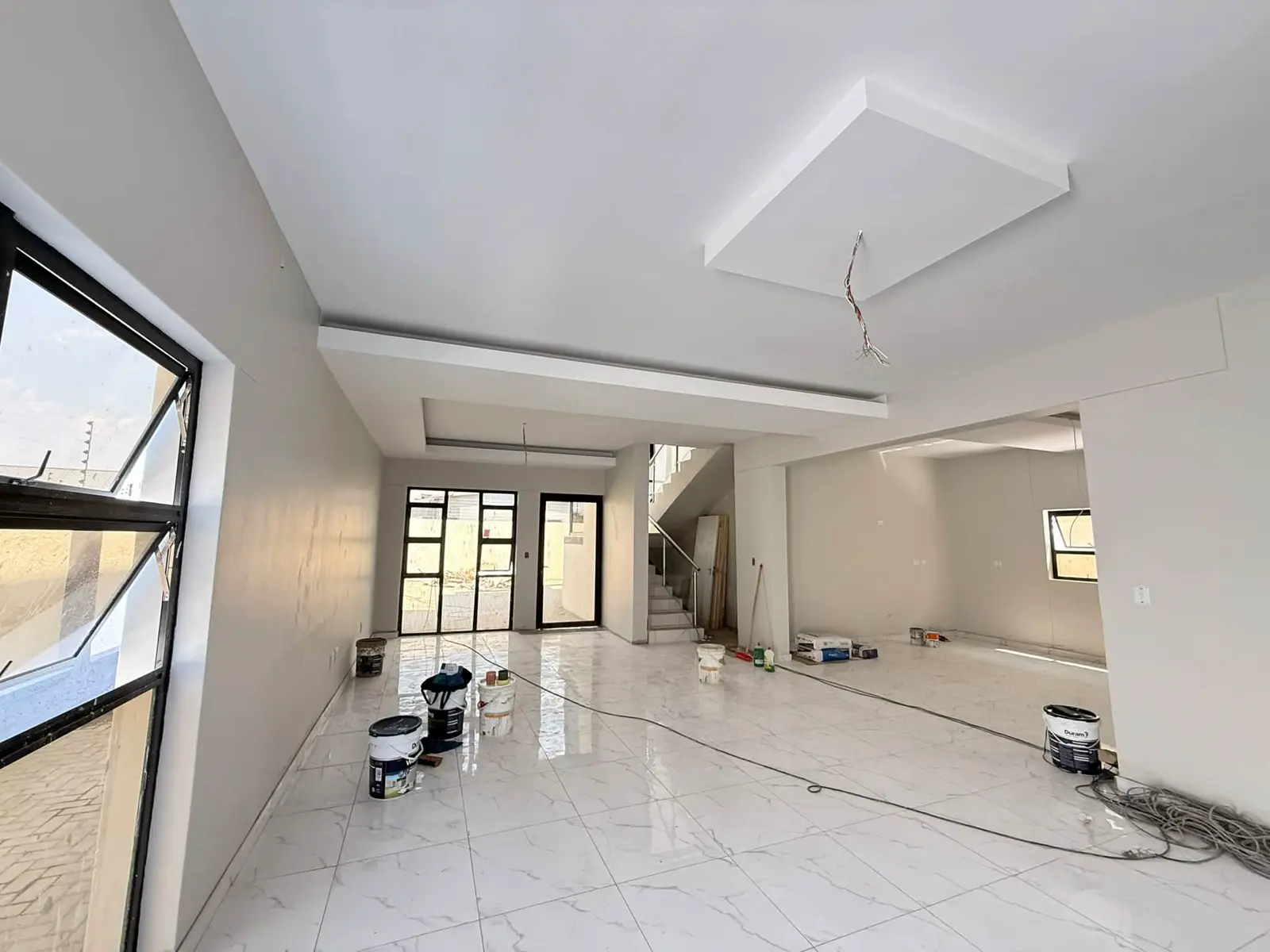 Ground floor: Open-plan living area, stairs at the back